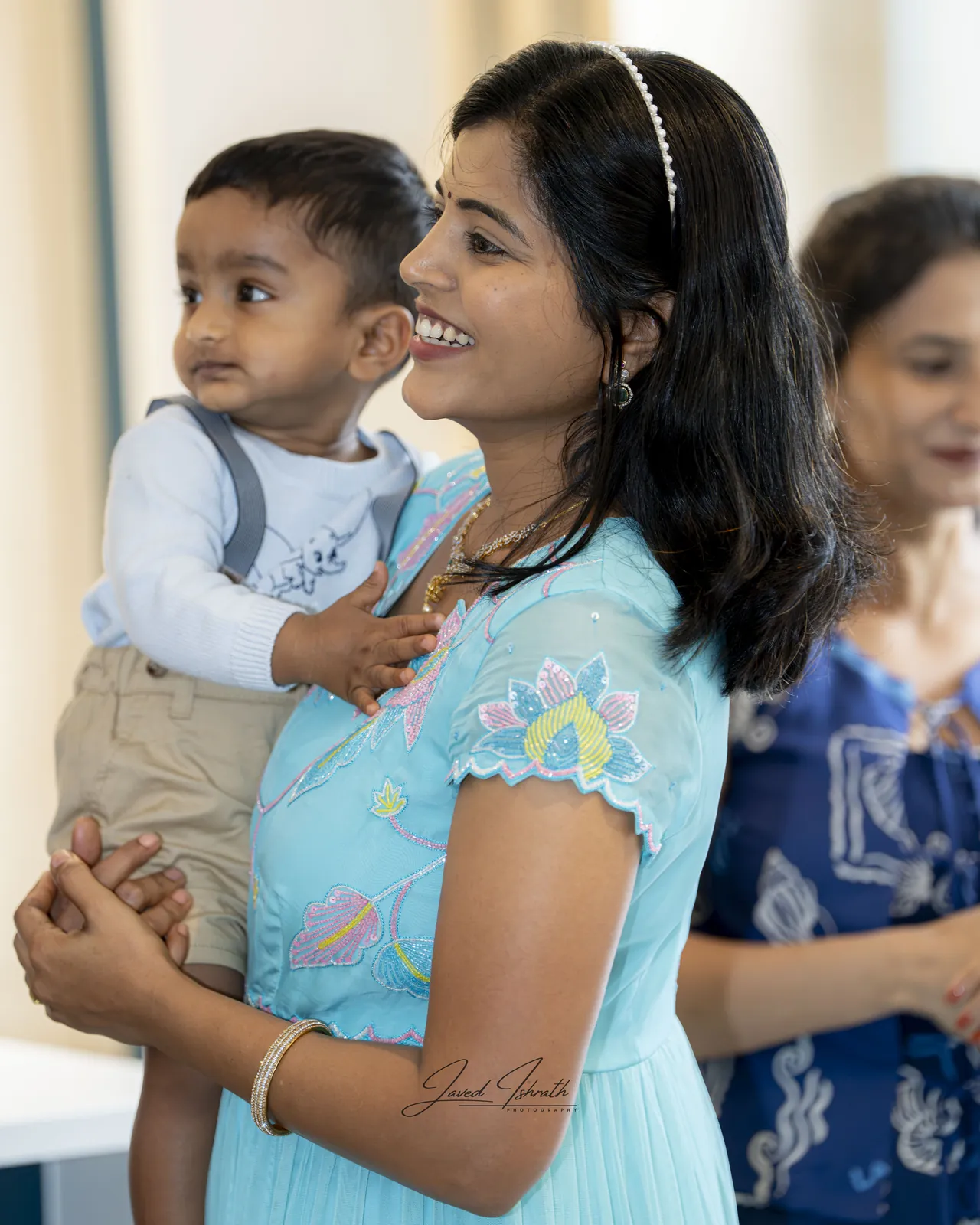 A mother holding her son at his first birthday